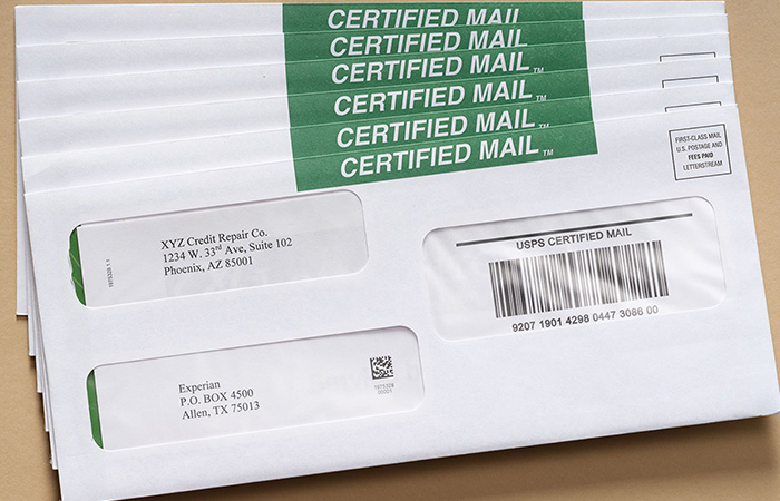 A small stack of certified mail pieces fanned out on a tan background with a certified mail tracking number and certified mail barcode.