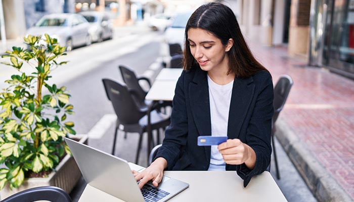 Woman sitting at computer on web portal for LetterStream.com to upload his mail and print job.